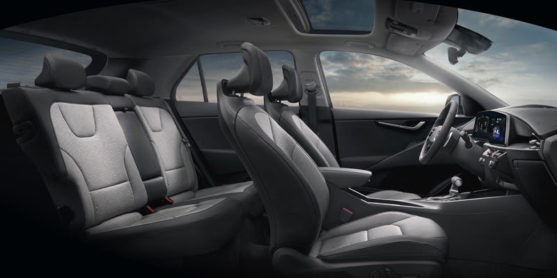 Spacious car interior showing front and rear seats with sunroof