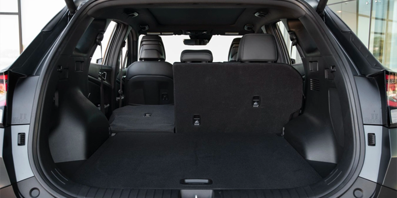 View of a car's spacious trunk, with half of the rear seats folded down for increased cargo capacity.
