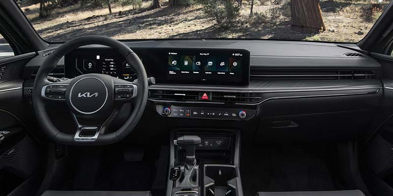 Car dashboard with infotainment screen and steering wheel view