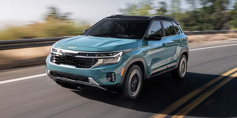 Kia compact SUV driving on an open road highlighting exterior styling and advanced features