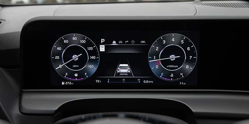 Digital car dashboard displaying speedometer (0 mph), tachometer (0 RPM), lane assist, and adaptive cruise control.